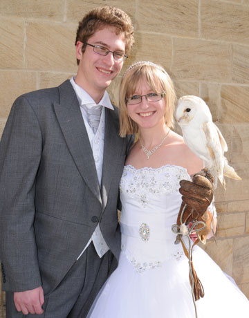 Bride and groom with their ring delivery barn owl